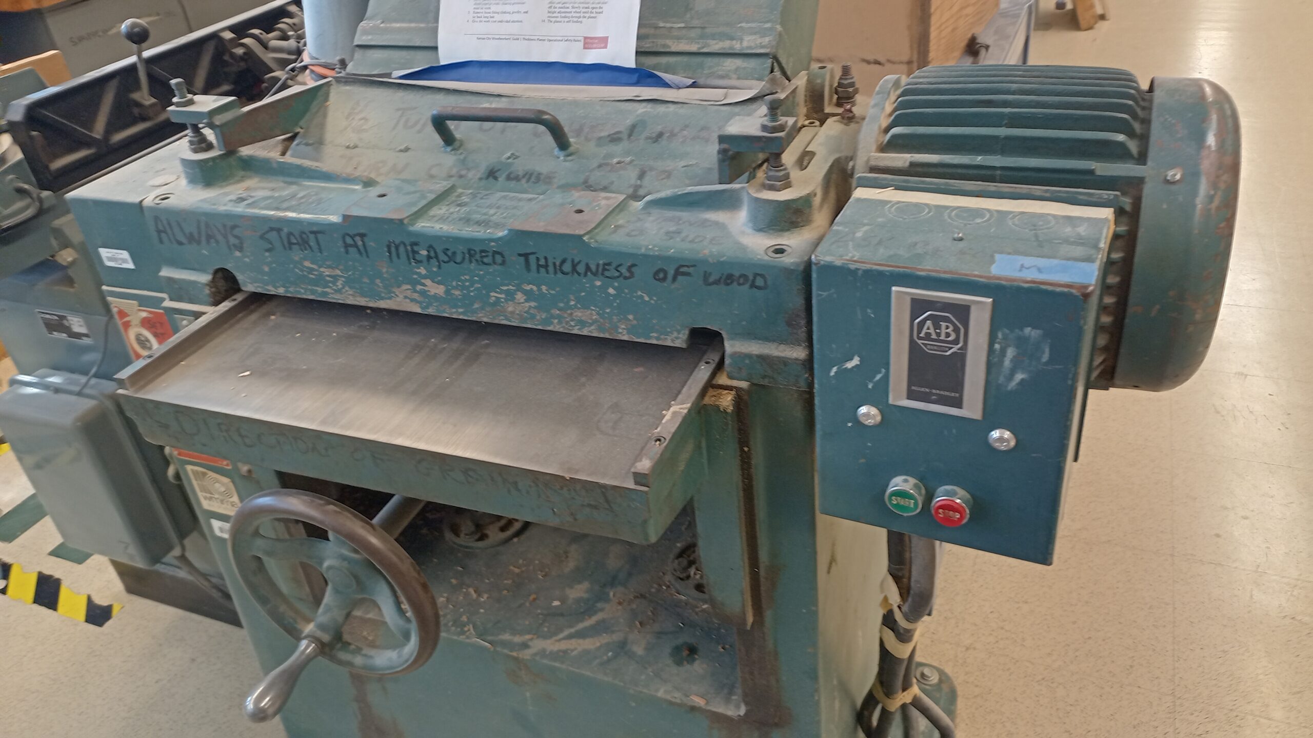 Thickness planer or similar woodworking machine in the shop